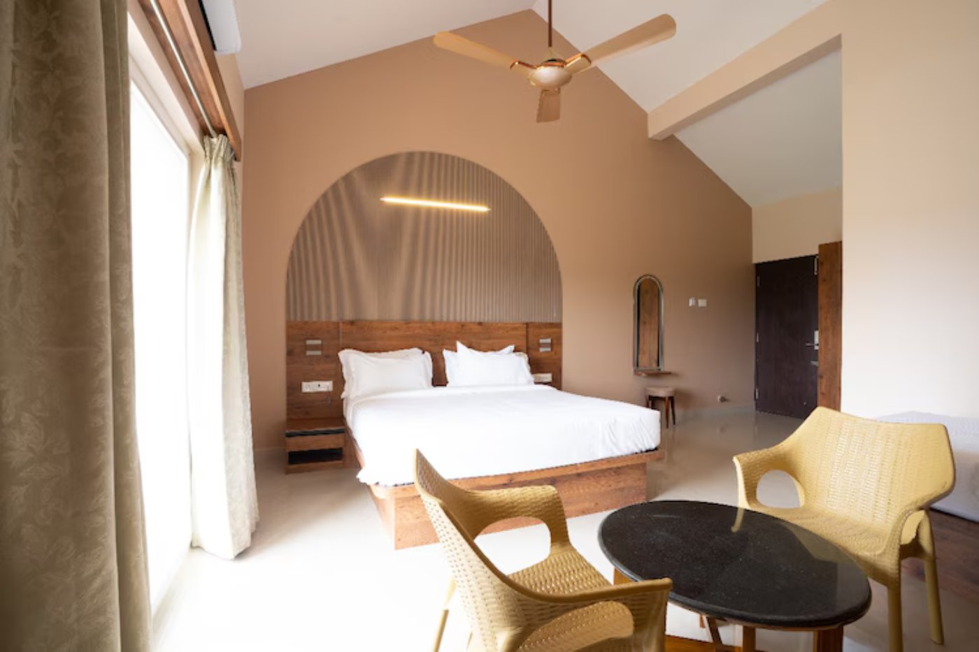King bed with work desk in a family suite room in Yelagiri