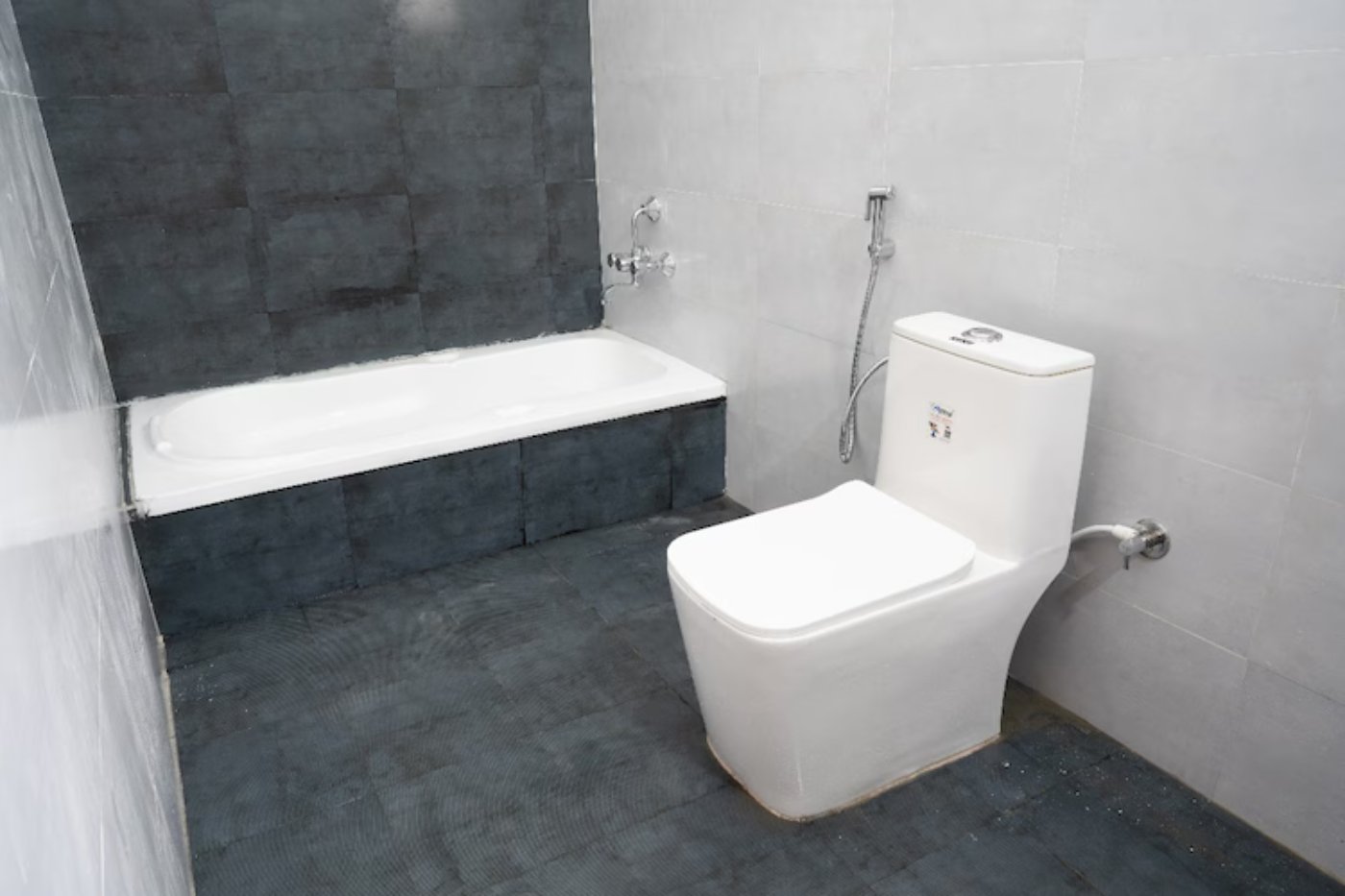 Clean private bathroom with a western toilet in a Yelagiri family resort